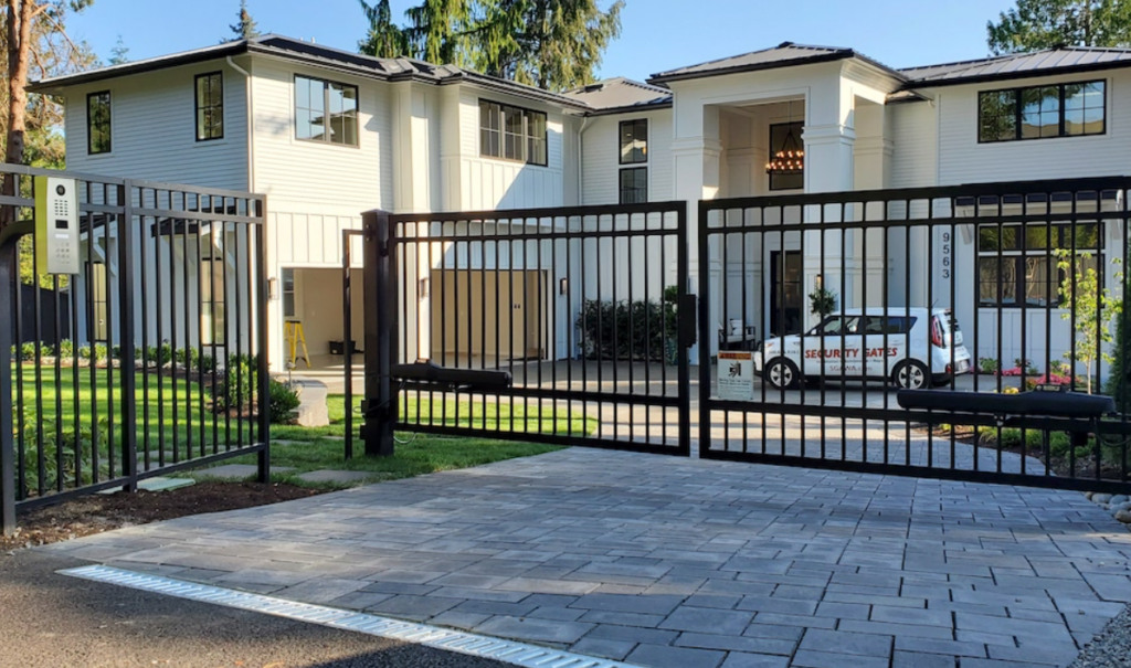 A large home with an automated gate out front 