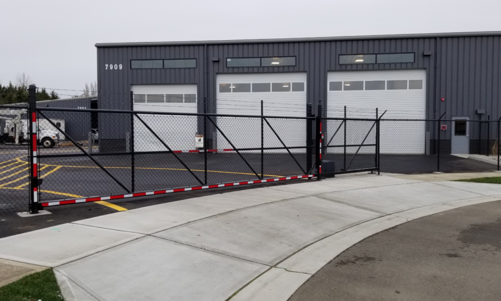 A commercial building with three garages being protected by a commercial gate | winterize commercial gates