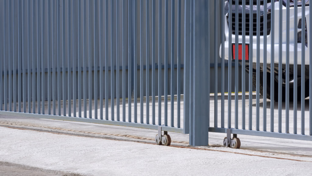 close-up shot of an automatic gate with a car behind it